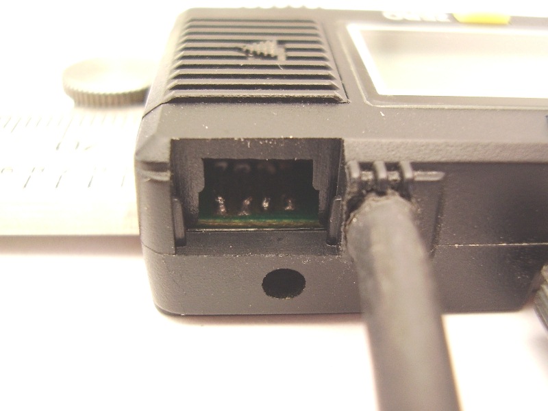 Data cable inserted next to interface port